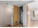 Utility room featuring water heater, brick wall, and wood-look floors at 5339 N Black Canyon Hwy, Phoenix, AZ 85015