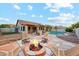 Inviting backyard oasis with a pool, a fire pit with lounge chairs, and an outdoor kitchen perfect for entertaining at 5830 W Cinnabar Ave, Glendale, AZ 85302
