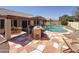 Beautiful backyard oasis features a pool, outdoor kitchen, and spacious patio perfect for entertaining and relaxation at 5830 W Cinnabar Ave, Glendale, AZ 85302