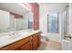 Well-lit bathroom featuring a double sink vanity and a separate toilet area at 5830 W Cinnabar Ave, Glendale, AZ 85302