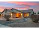 Charming single-story home featuring desert landscaping, warm exterior lighting and a tile roof at 5830 W Cinnabar Ave, Glendale, AZ 85302