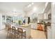 Bright kitchen boasts stainless steel appliances, granite countertops, a spacious island, and bar stool seating at 5830 W Cinnabar Ave, Glendale, AZ 85302