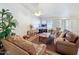 Inviting living room featuring comfortable leather sofas and a ceiling fan at 5830 W Cinnabar Ave, Glendale, AZ 85302