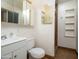 Bathroom featuring step-in shower, vanity, toilet, and storage shelves at 6320 N 30Th Dr, Phoenix, AZ 85017