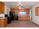 Kitchen with a ceiling fan, black appliances, and wood cabinets at 6320 N 30Th Dr, Phoenix, AZ 85017