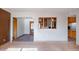 View of the living room with tile floors, multiple doorways, and brick wall at 6320 N 30Th Dr, Phoenix, AZ 85017