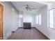 Bright living room with tile floors, fireplace, ceiling fan, and multiple windows at 6320 N 30Th Dr, Phoenix, AZ 85017