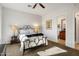 Bedroom with neutral walls, comfortable bed, lamps, and ensuite bathroom at 6522 N 27Th St, Phoenix, AZ 85016