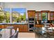Charming kitchen with wood cabinetry and a granite island, ideal for cooking and entertaining at 6522 N 27Th St, Phoenix, AZ 85016