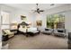 Bright main bedroom featuring neutral decor, large windows overlooking desert landscaping, and a comfortable seating area at 6522 N 27Th St, Phoenix, AZ 85016