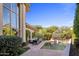 A serene backyard pool featuring an attached hot tub, lounge seating, and lush landscaping at 6522 N 27Th St, Phoenix, AZ 85016