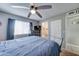 This bedroom has an ensuite bathroom, neutral color scheme, ample natural light, and carpet flooring at 701 N 95Th Cir, Mesa, AZ 85207