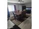 A dining room set with a wooden table and upholstered chairs, featuring an aquarium at 701 N 95Th Cir, Mesa, AZ 85207
