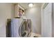 Laundry room showing side-by-side washer and dryer with cabinet for storage at 701 N 95Th Cir, Mesa, AZ 85207