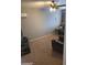 The living room has comfortable seating, a ceiling fan, and wall-mounted air conditioning at 701 N 95Th Cir, Mesa, AZ 85207