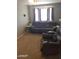 Spacious living room with plush seating and natural light, carpeted floor, and neutral tones at 701 N 95Th Cir, Mesa, AZ 85207