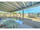 Covered patio showing backyard, trampoline and detached storage structure at 701 N 95Th Cir, Mesa, AZ 85207