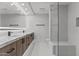 Well-lit bathroom featuring dual sinks, large mirror, and a sleek glass-enclosed shower at 7157 E Rancho Vista Dr # 3001, Scottsdale, AZ 85251