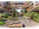 Beautiful open-air courtyard with a decorative rock garden featuring bench seating and lush, mature landscaping at 7157 E Rancho Vista Dr # 3001, Scottsdale, AZ 85251