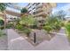 Low angle of courtyard view with well-maintained plants and trees surrounding walking paths at 7157 E Rancho Vista Dr # 3001, Scottsdale, AZ 85251