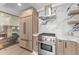 Bright kitchen with stainless steel appliances, marble countertops, and stylish cabinetry at 7157 E Rancho Vista Dr # 3001, Scottsdale, AZ 85251