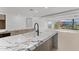 Kitchen with marble island counter and black fixtures near sliding glass doors at 7157 E Rancho Vista Dr # 3001, Scottsdale, AZ 85251