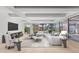 Bright living room featuring floor-to-ceiling windows and a modern sectional sofa with stylish decor at 7157 E Rancho Vista Dr # 3001, Scottsdale, AZ 85251