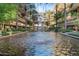 Stunning courtyard featuring a large water feature with lush landscaping and luxury condominium buildings surrounding it at 7157 E Rancho Vista Dr # 3001, Scottsdale, AZ 85251