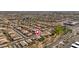 An aerial view of a neighborhood with organized streets, green spaces, and desert landscaping at 7214 N 88Th Ln, Glendale, AZ 85305