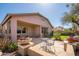 Inviting backyard featuring a covered patio, seating, and mature landscaping at 7214 N 88Th Ln, Glendale, AZ 85305