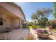 Charming backyard oasis with seating area and a lovely garden at 7214 N 88Th Ln, Glendale, AZ 85305