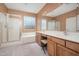 Main bathroom with a double vanity, separate shower, bathtub, and great lighting at 7214 N 88Th Ln, Glendale, AZ 85305