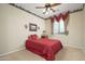 Cozy bedroom featuring natural light, ceiling fan, and fun wallpaper border at 7214 N 88Th Ln, Glendale, AZ 85305