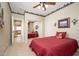 Bedroom featuring natural light, ceiling fan, and mirrored closet at 7214 N 88Th Ln, Glendale, AZ 85305