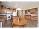 Bright kitchen with ample cabinet space, an island, and a cozy dining area featuring wood floors at 7214 N 88Th Ln, Glendale, AZ 85305