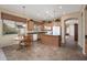 Bright kitchen featuring an island, neutral paint, tile floors, wood cabinets, and a breakfast nook at 7214 N 88Th Ln, Glendale, AZ 85305