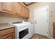 Laundry room featuring newer washer and dryer units and plenty of storage at 7214 N 88Th Ln, Glendale, AZ 85305