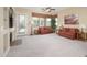 Inviting living room filled with natural light, neutral carpet, and cozy seating with views of backyard at 7214 N 88Th Ln, Glendale, AZ 85305