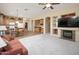 Open living space with neutral carpet combining a kitchen, dining, and living area, great for entertaining at 7214 N 88Th Ln, Glendale, AZ 85305