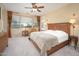 Serene main bedroom featuring large windows, soft lighting, and an en-suite bathroom at 7214 N 88Th Ln, Glendale, AZ 85305