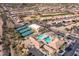 Gorgeous aerial view of community featuring pool, tennis courts, clubhouse and landscaping at 7380 E Canyon Wren Dr, Gold Canyon, AZ 85118