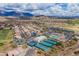 Beautiful aerial view of a golf course community with mountain views, tennis courts, and sparkling pools at 7380 E Canyon Wren Dr, Gold Canyon, AZ 85118