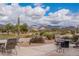 A well-maintained backyard features cozy seating, with views of the desert landscape and mountain scenery at 7380 E Canyon Wren Dr, Gold Canyon, AZ 85118