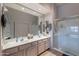 Well-lit bathroom with double vanity, neutral countertops, and a glass enclosed shower at 7380 E Canyon Wren Dr, Gold Canyon, AZ 85118