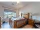 Bright bedroom features a wooden bed frame, a large window, and light, neutral paint at 7380 E Canyon Wren Dr, Gold Canyon, AZ 85118