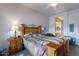 Bedroom featuring a wooden bed frame, a large window and an ensuite bathroom at 7380 E Canyon Wren Dr, Gold Canyon, AZ 85118