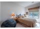 Cozy bedroom featuring a large window and comfortable furnishings at 7380 E Canyon Wren Dr, Gold Canyon, AZ 85118