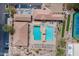 Aerial view of a resort-style community pool with blue water, lounge seating, and shade canopies at 7380 E Canyon Wren Dr, Gold Canyon, AZ 85118