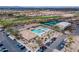 Resort-style community pool and amenity center with lush landscaping, golf course, and tennis courts at 7380 E Canyon Wren Dr, Gold Canyon, AZ 85118