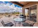 Inviting covered patio with dining and grilling areas, offering stunning views of the surrounding landscape at 7380 E Canyon Wren Dr, Gold Canyon, AZ 85118